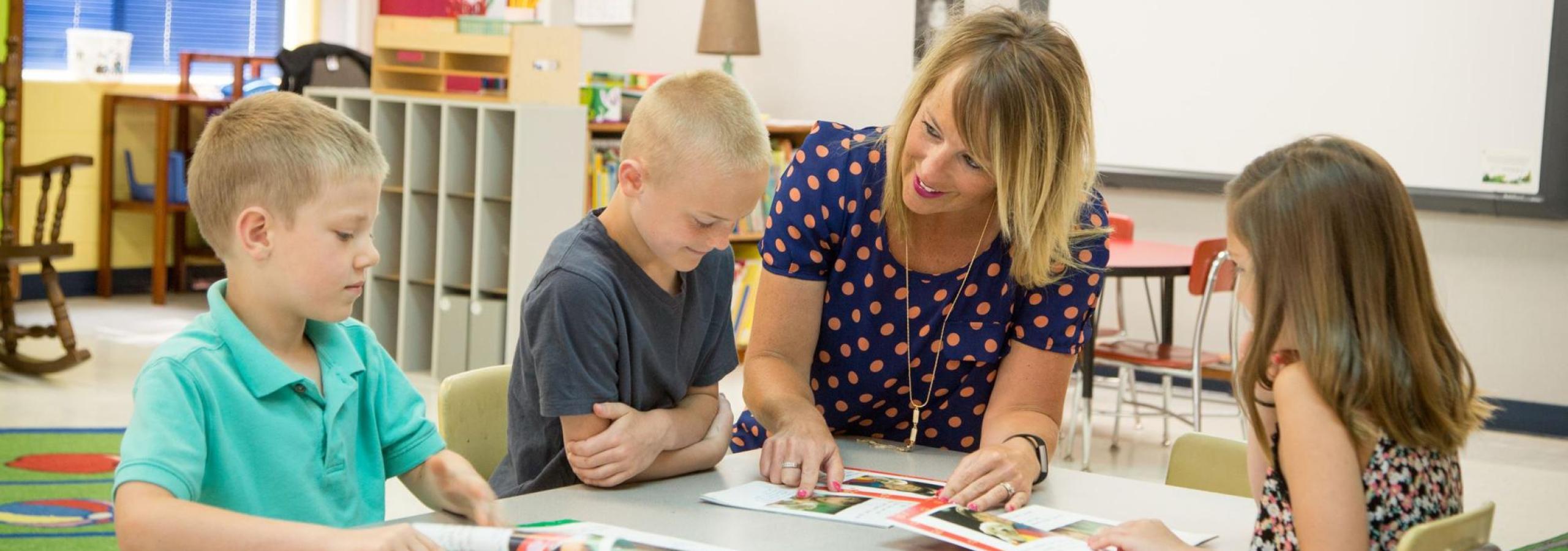 Teacher with young students.